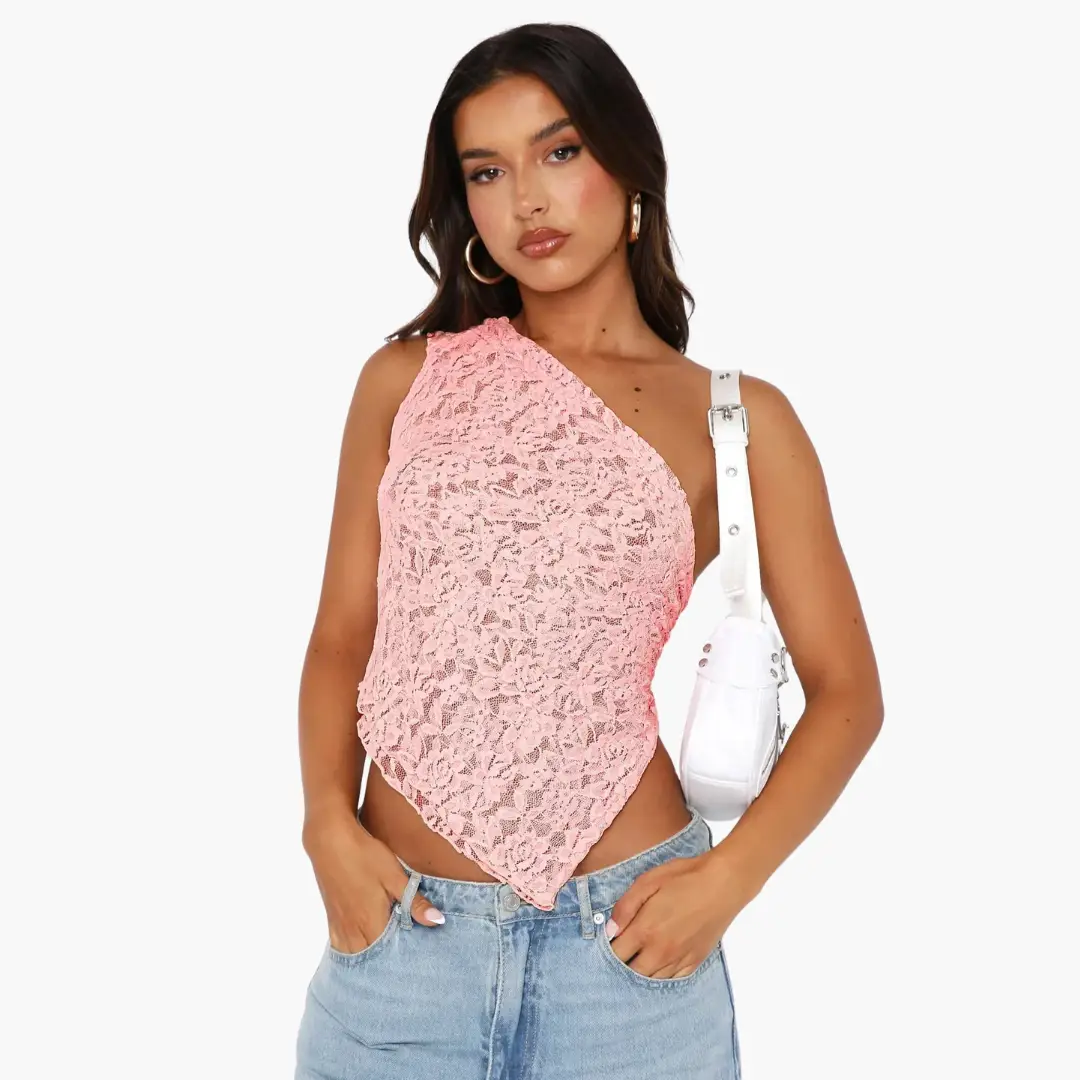 Lace one-shoulder top for women, pink with an asymmetrical neckline, shown on model wearing jeans.