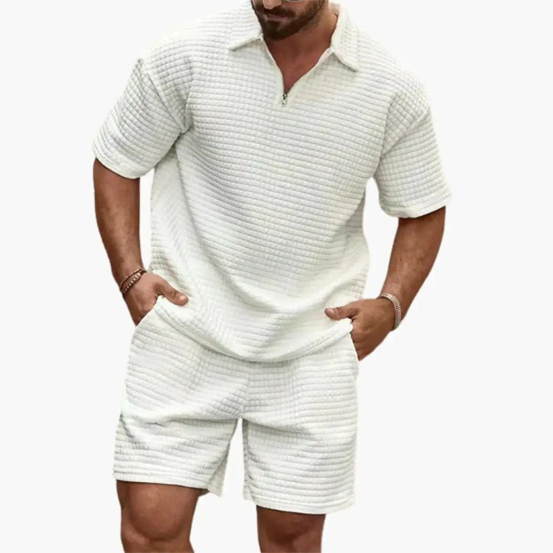 Men's white quilted two-piece set: short-sleeve top with half-zip and matching quilted shorts.