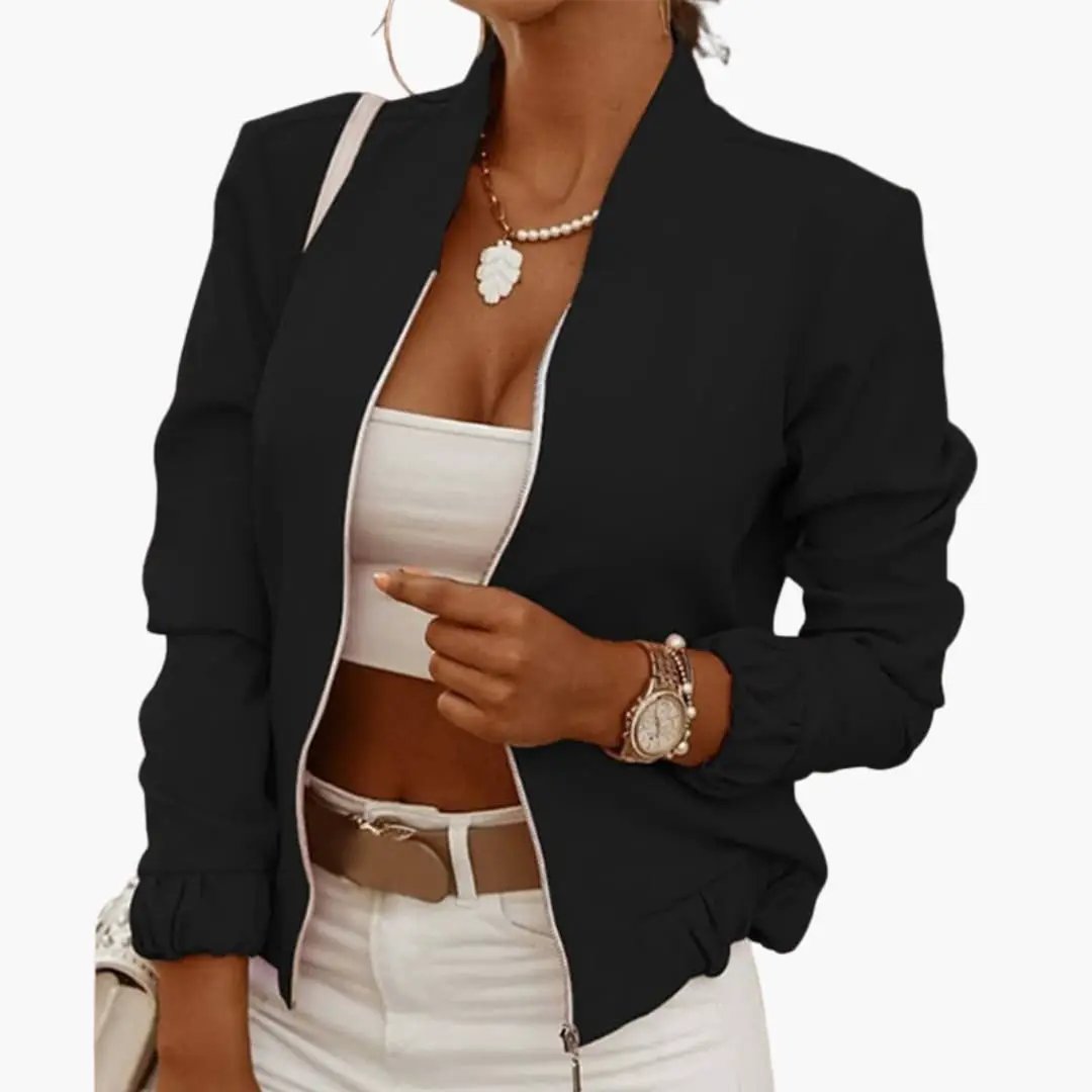 Elegant transitional jacket for women in black, open-front blazer over white top and pants, with necklace and watch