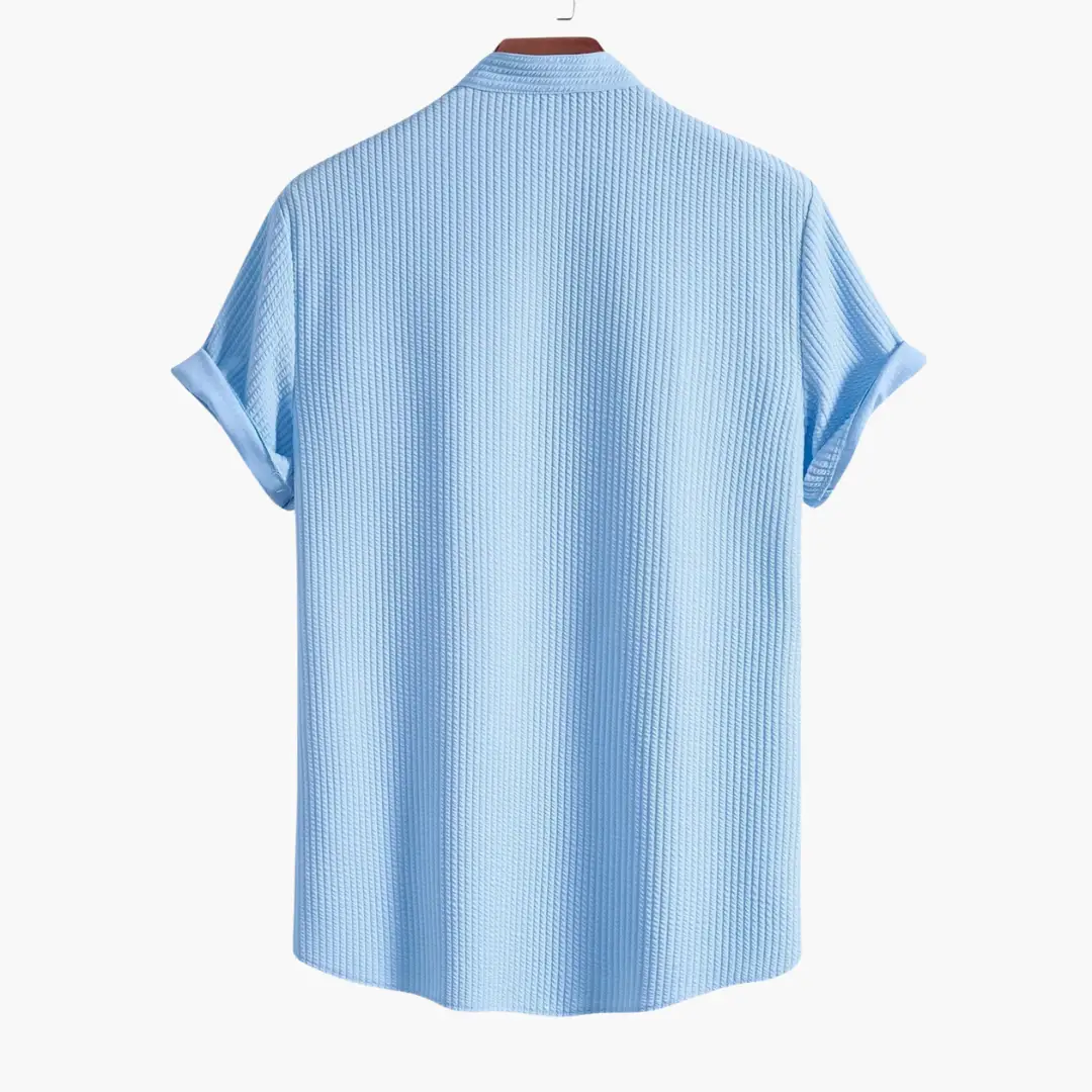Men's shirt with stand collar in light blue ribbed fabric, back view, rolled sleeves, Wilfred Smith