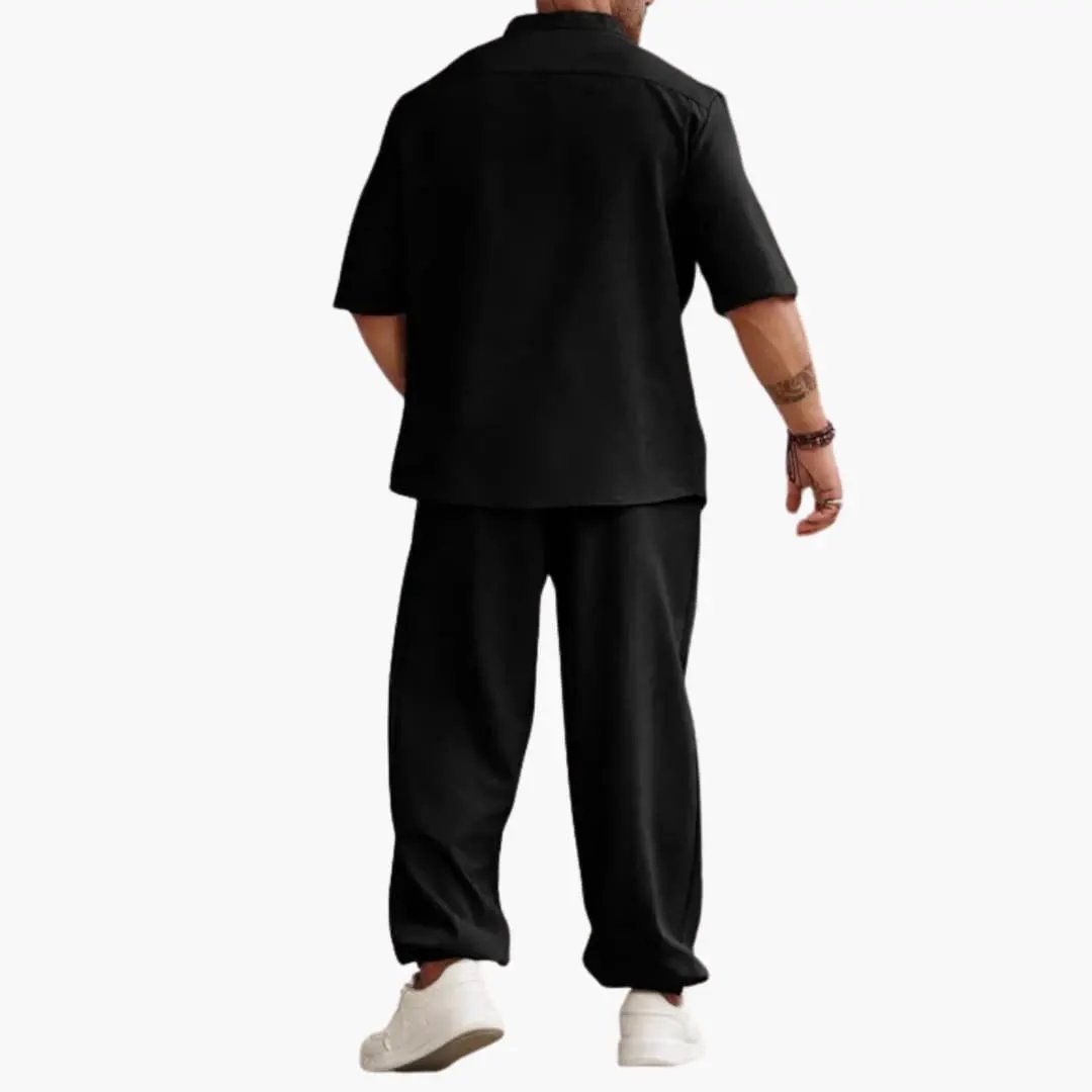 Men's black short-sleeve shirt and long black pants set, back view with white sneakers