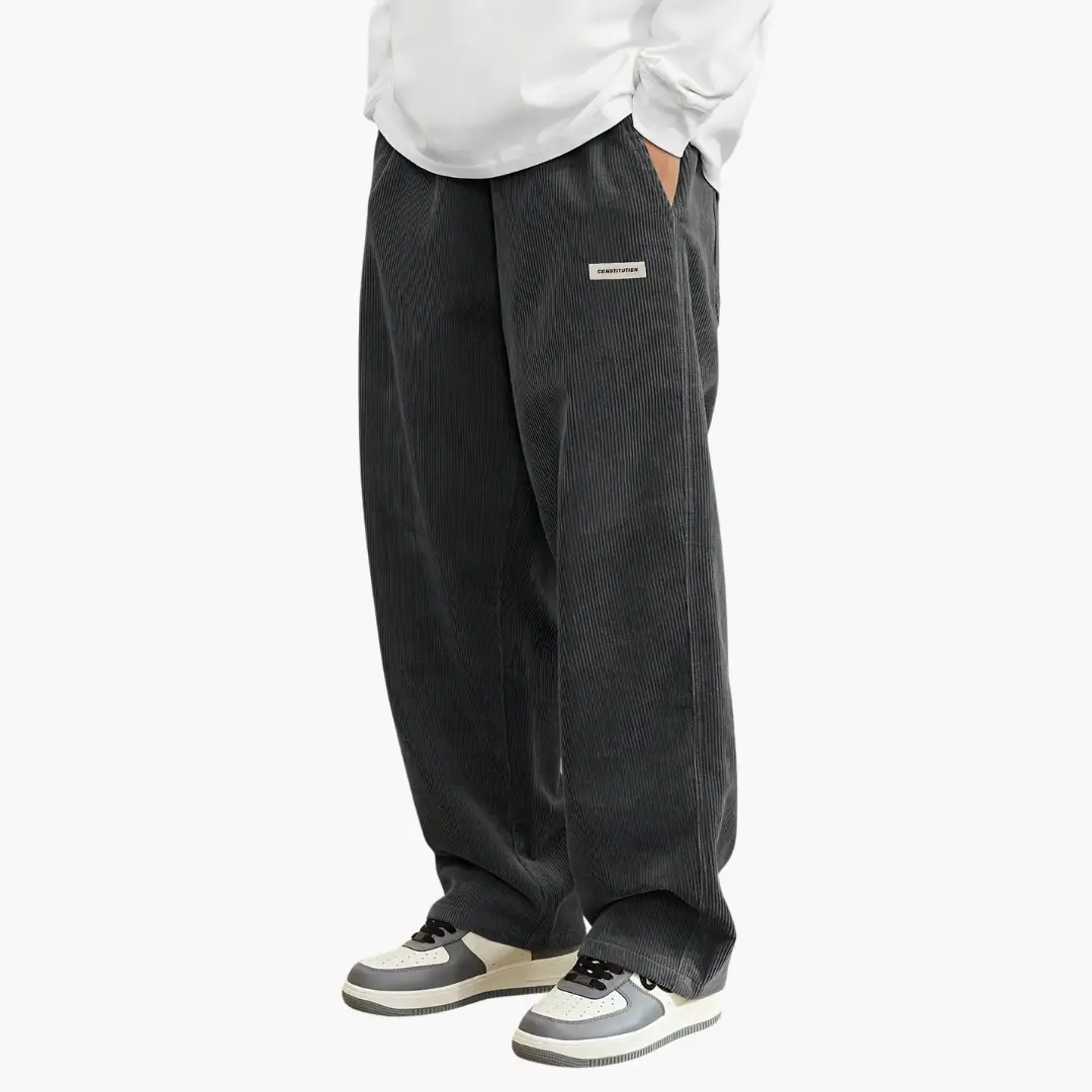 Men's corduroy pants in dark gray by Wilfred Smith with pockets and a wide leg