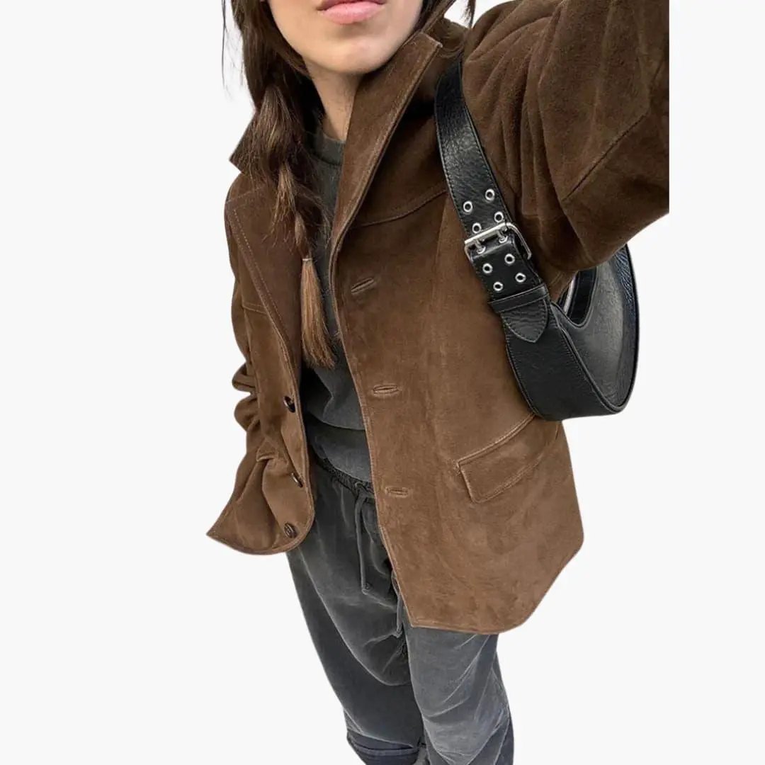 Trendy women's suede jacket with button placket in brown, shown with black shoulder bag.