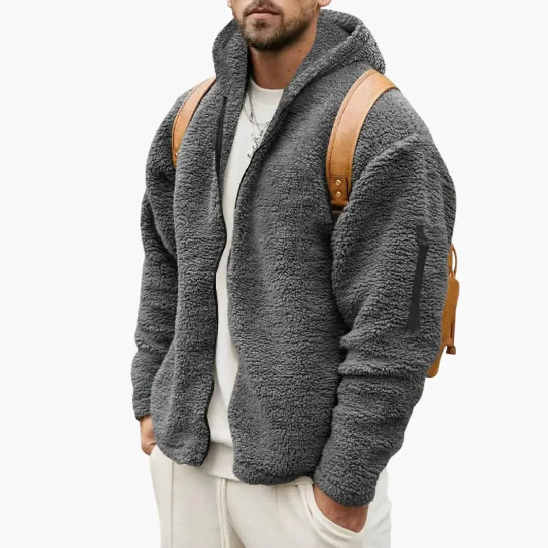 Men’s hooded jacket with textured gray fleece, front zip closure, worn with a brown backpack