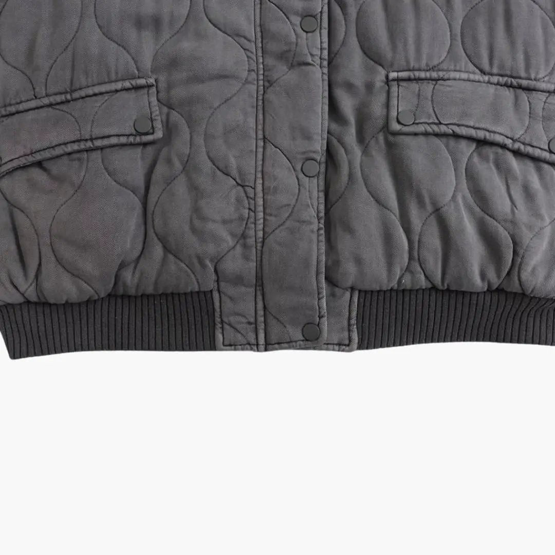 Wilfred Smith women's quilted bomber jacket in dark gray with snap-front placket and ribbed hem.