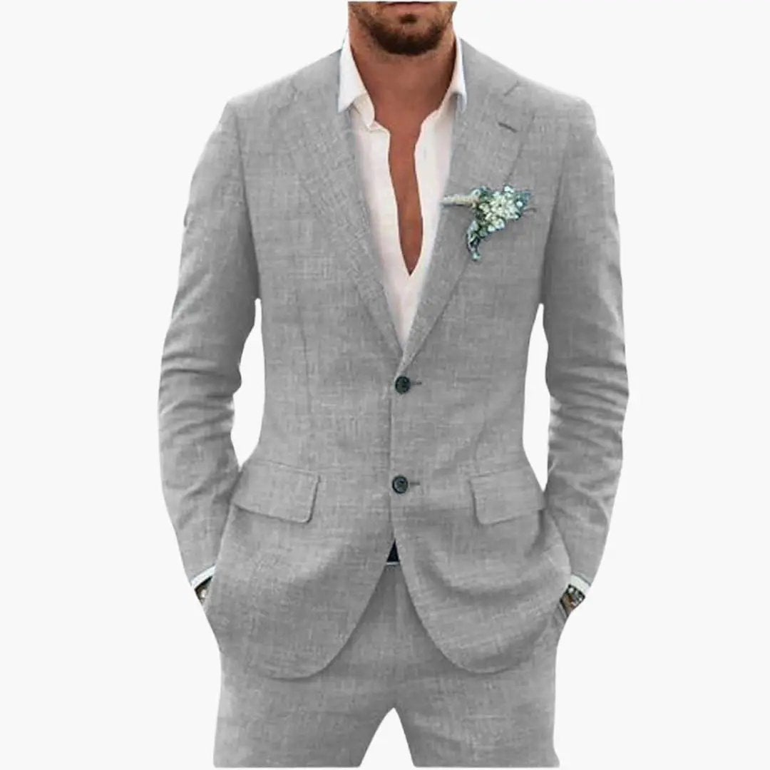 Men's light gray two-piece wedding suit by Wilfred Smith with notched lapel and button closure.