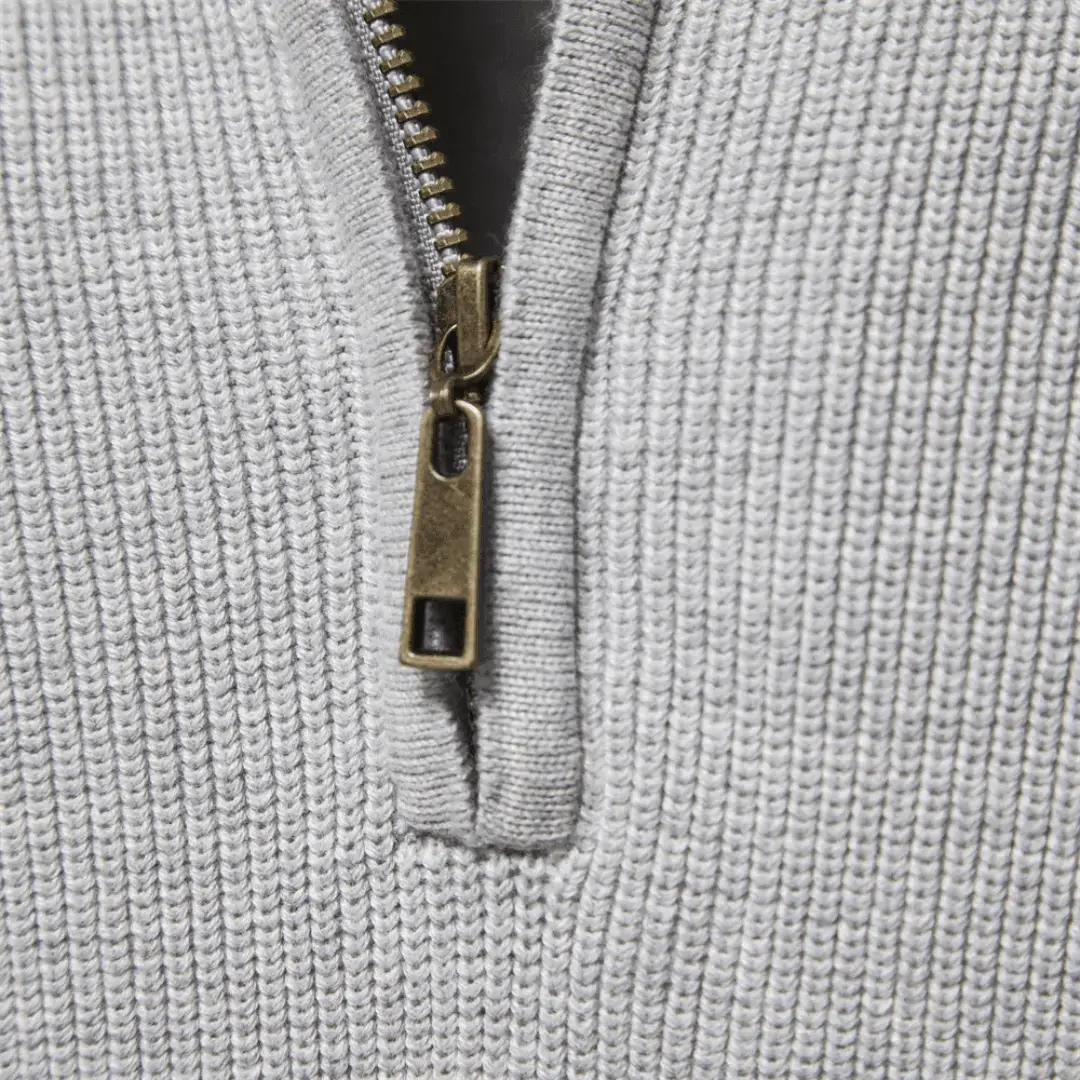 Knitted sweater for men, gray fabric with brass zipper close-up