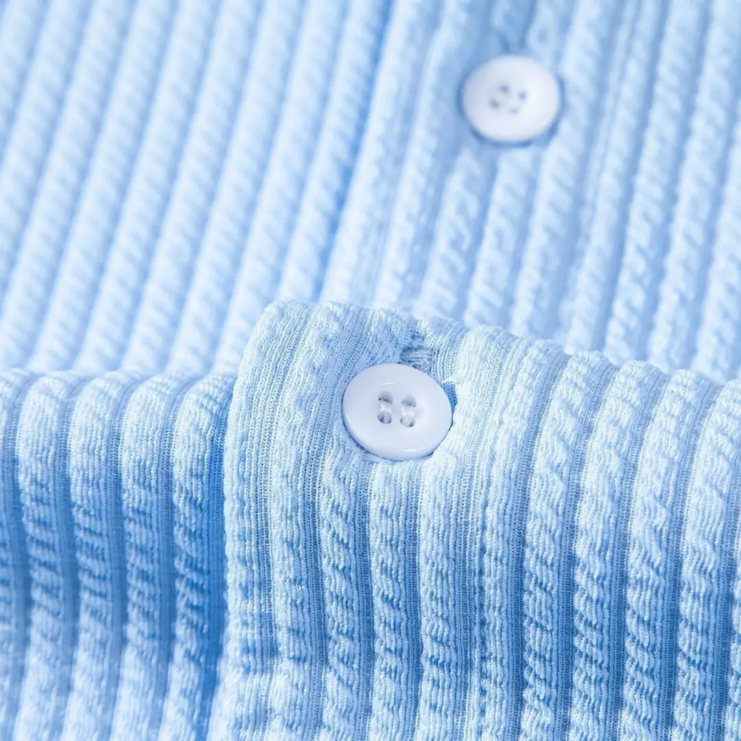 Men's shirt by Wilfred Smith with stand collar, light blue striped fabric and white buttons.