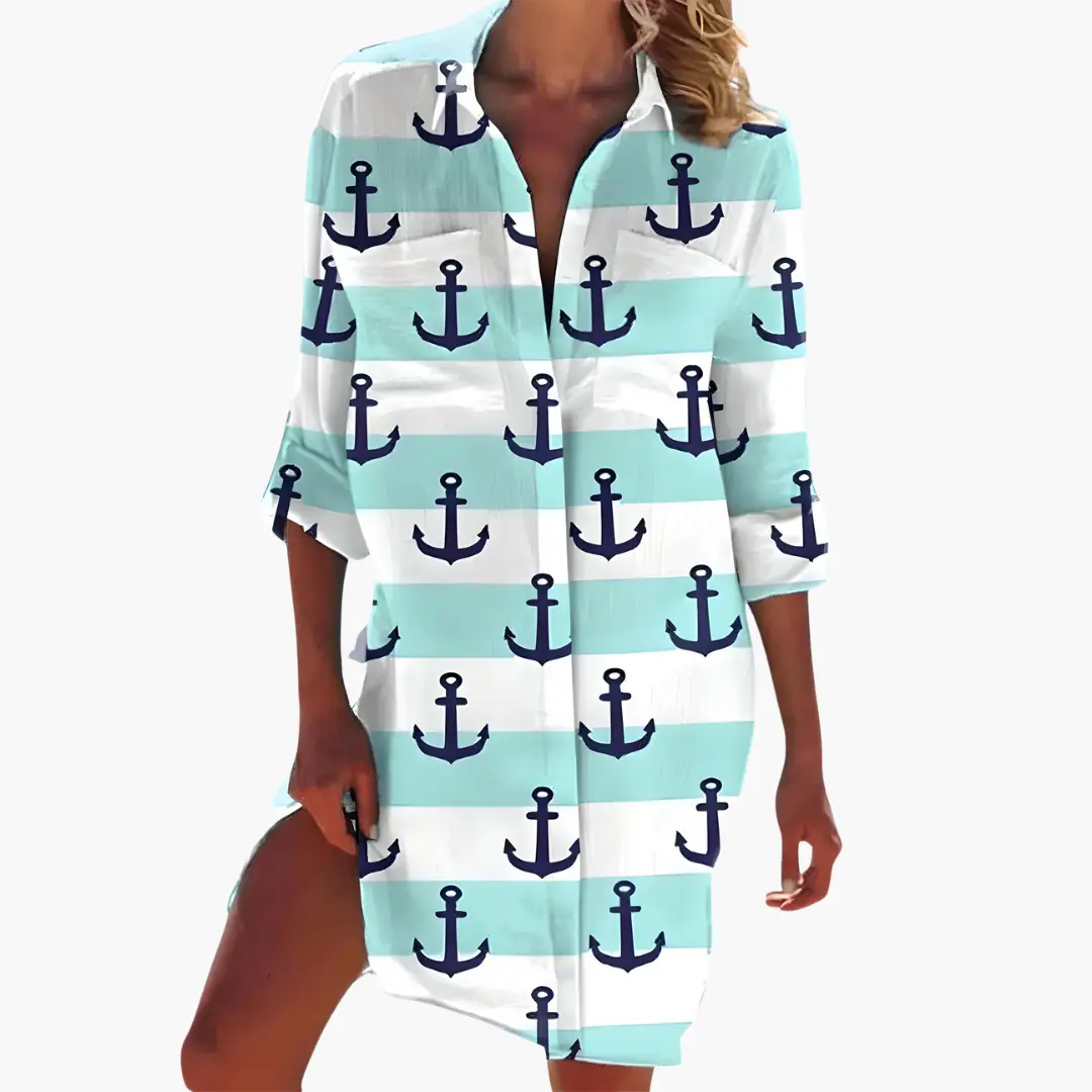 Women's shirt dress with navy anchor print on aqua and white striped fabric, long sleeves.