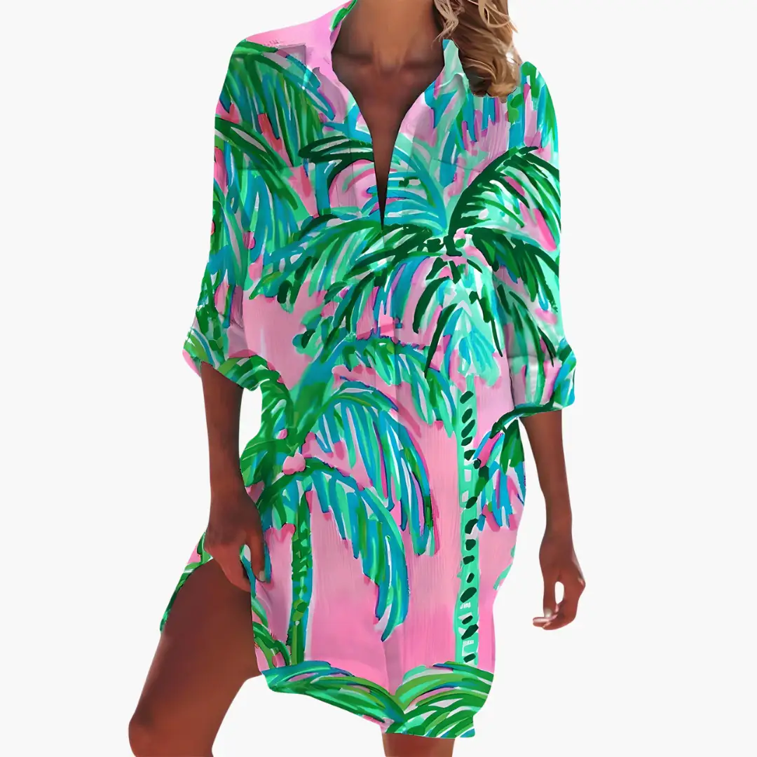 Women's shirt dress with long sleeves and button placket in vibrant pink tropical palm print