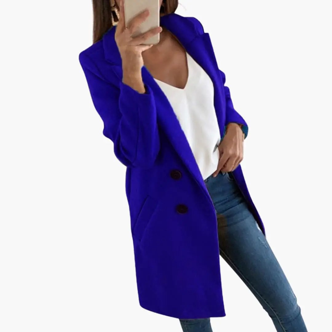 Blue button-closure coat for women, double-breasted with front pockets worn over white top and jeans