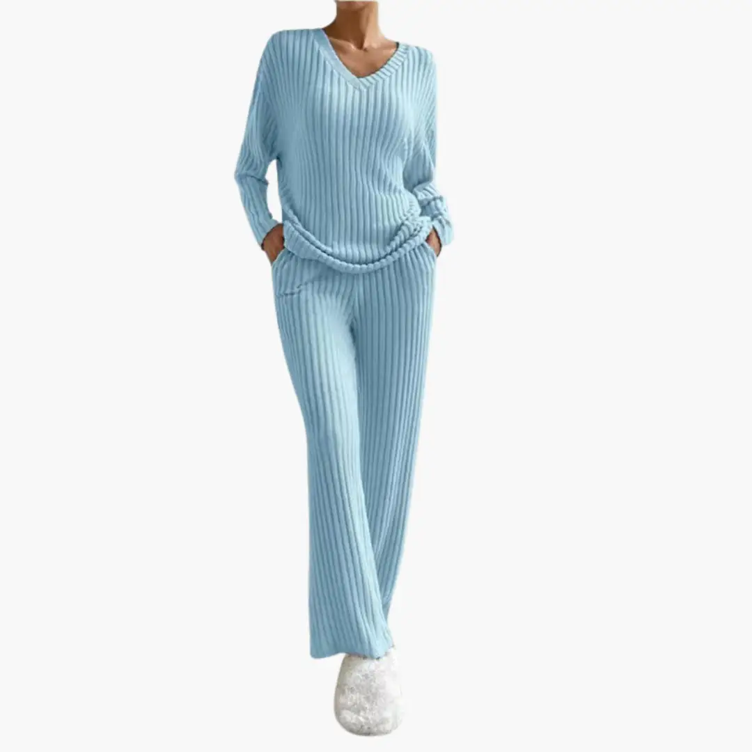Two-piece light blue ribbed knit lounge set with V-neck top and matching wide-leg pants, tied belt.