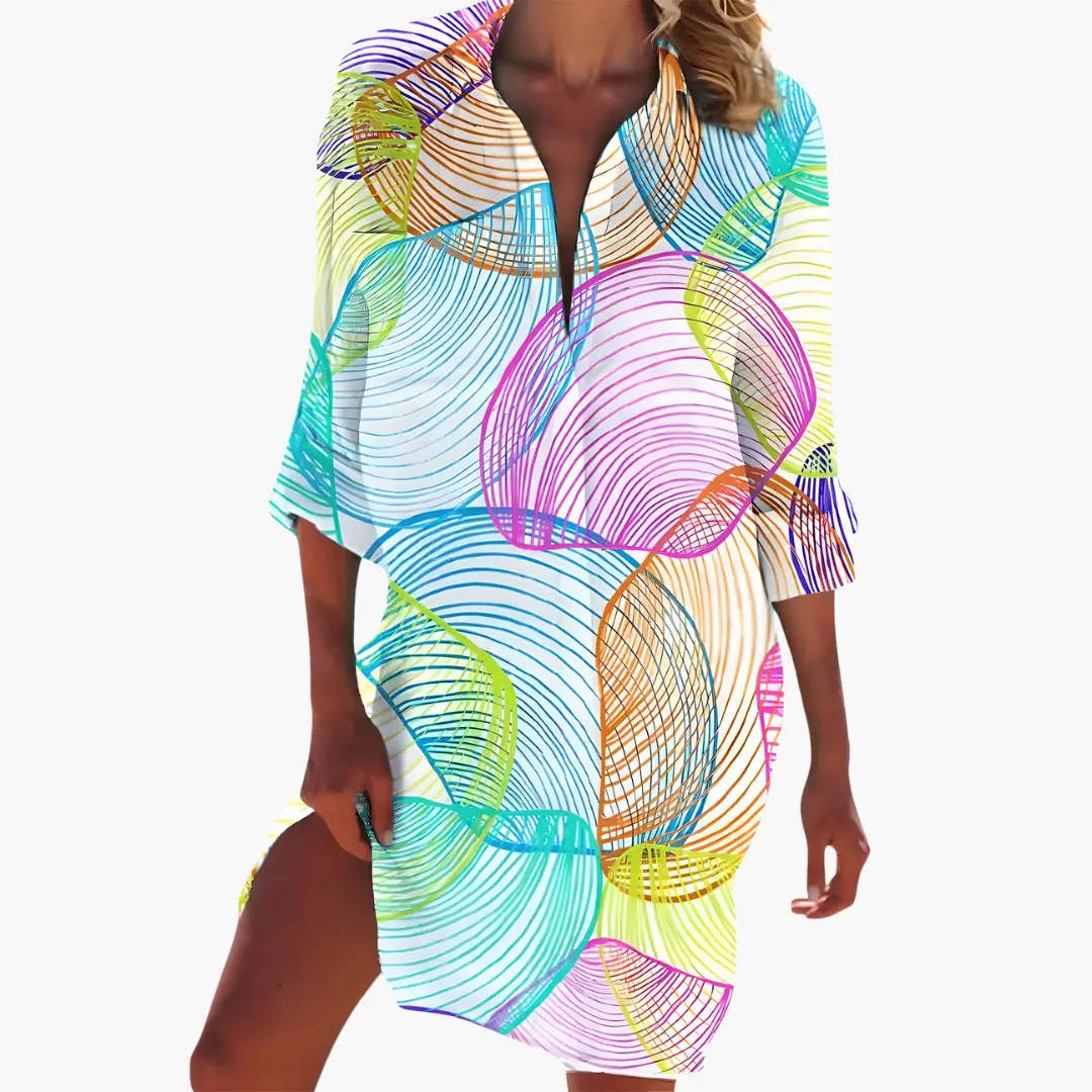 Women's shirt dress with long sleeves and button placket in a bold multicolor abstract print.