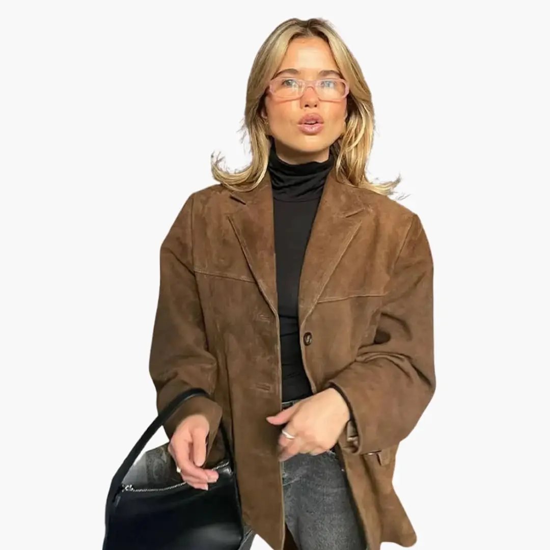 Women's oversized brown blazer with button closure and side pockets, styled with a black turtleneck.