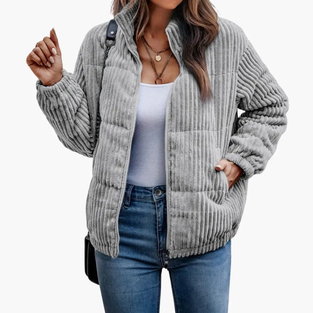 Women's gray ribbed zip jacket with front pockets, worn over a white tank and blue jeans
