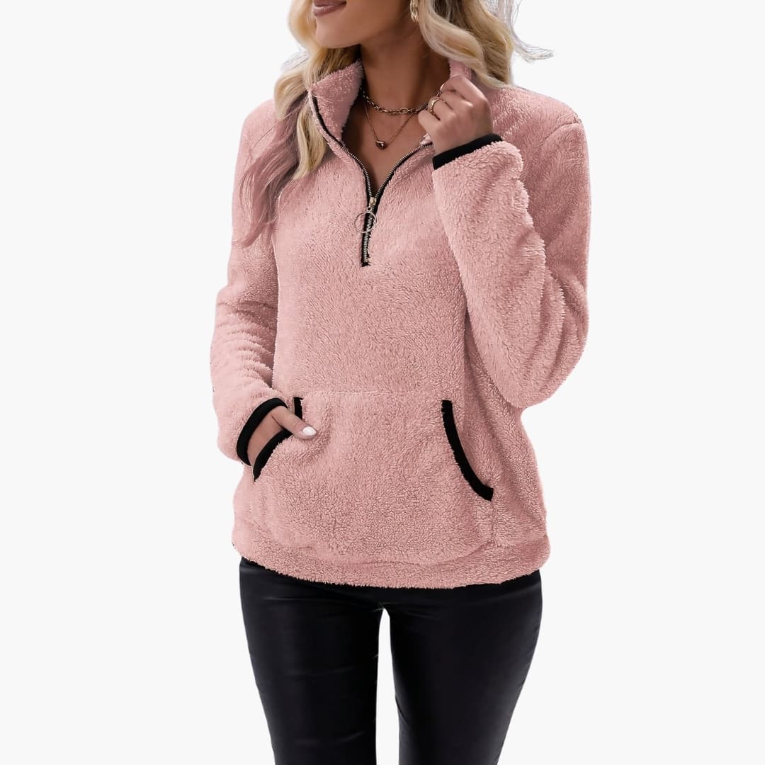 Women's pink fleece pullover with half-zip, front pockets, black trim on cuffs
