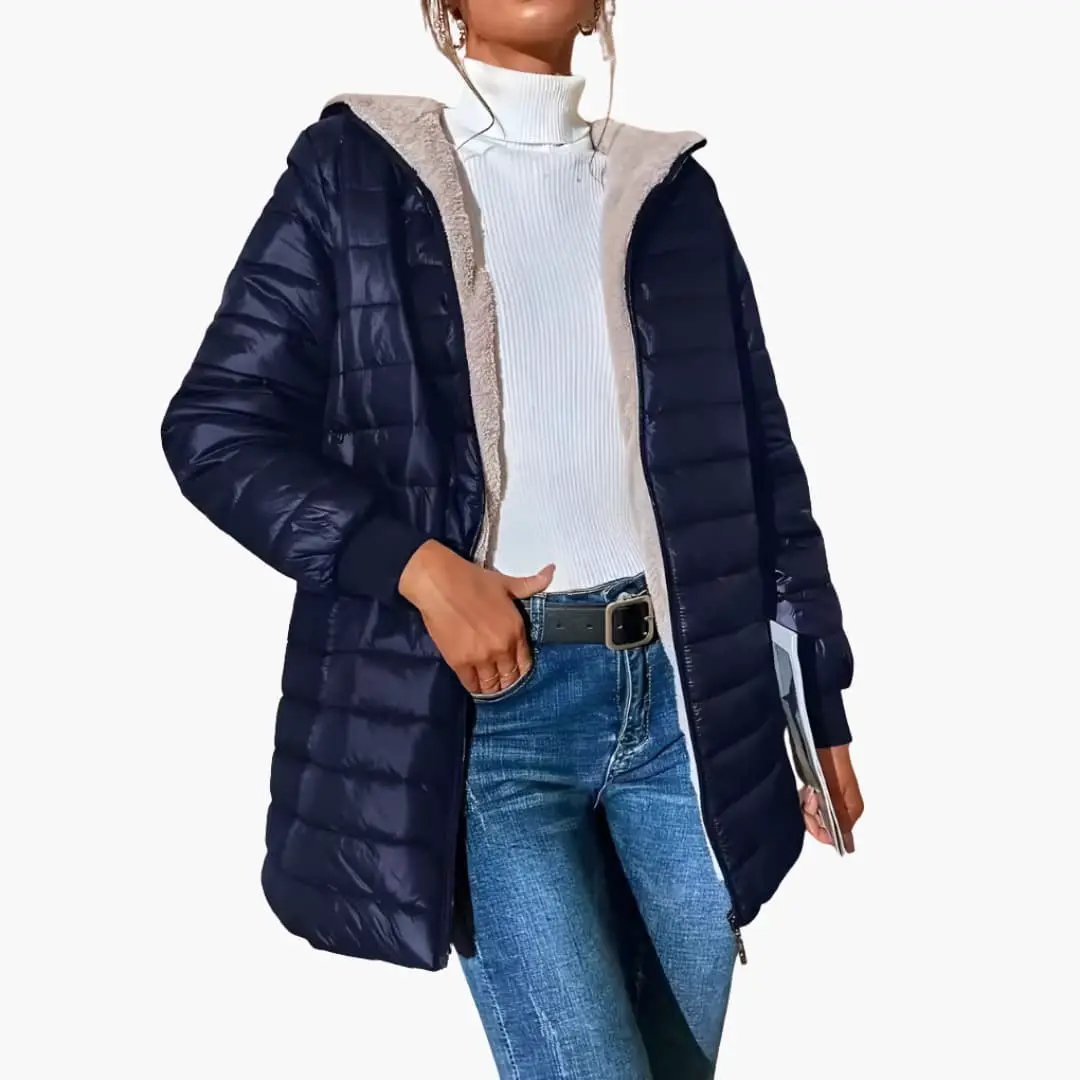 Women's navy quilted puffer coat with hood and zipper; beige sherpa lining, shown over white knit top and jeans