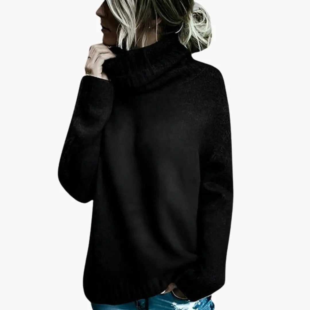 Women's oversized black knit sweater with long sleeves and turtleneck collar
