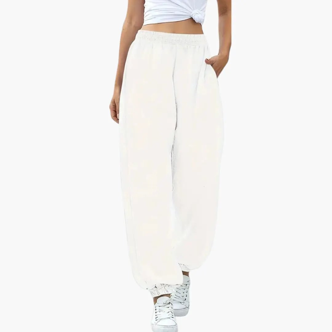 Women's baggy white sweatpants with side pockets, elastic waistband and cuffed ankles