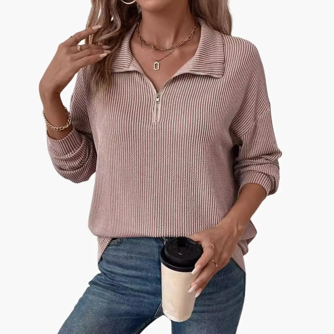 Women's striped knit sweater with a half-zip front in pink tones, relaxed fit, ribbed cuffs and collar, with jeans