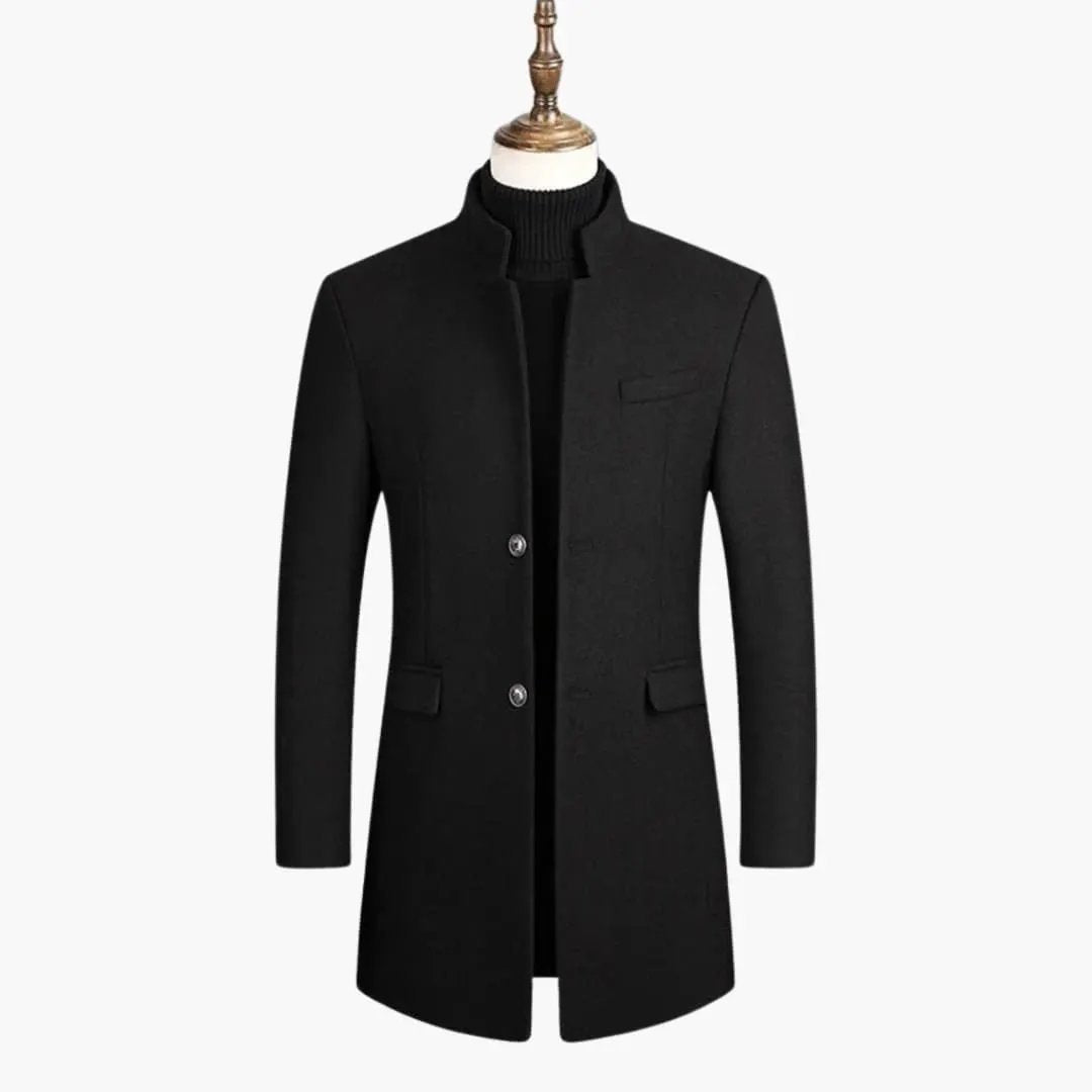 Men's long black coat with button closure, stand collar, chest welt pocket and flap pockets.