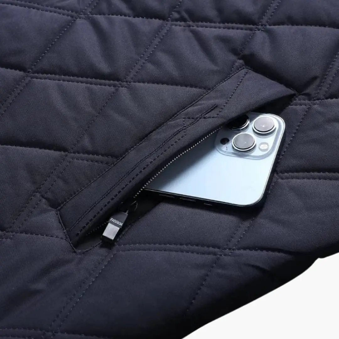Men's navy quilted jacket with lapel collar; zip pocket holding a smartphone.