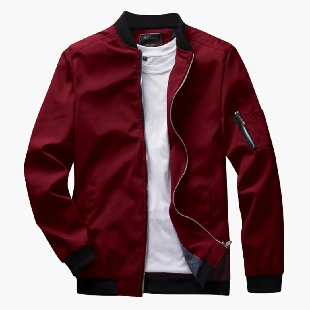 Men's bomber jacket by Wilfred Smith in burgundy with black ribbed collar and cuffs, sleeve zip pocket