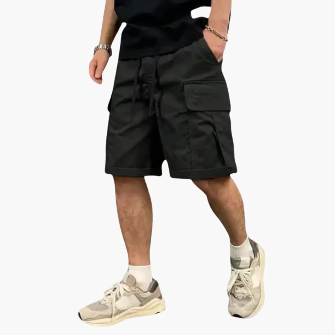Men's cargo shorts by Wilfred Smith, knee-length black with drawstring and flap pockets.