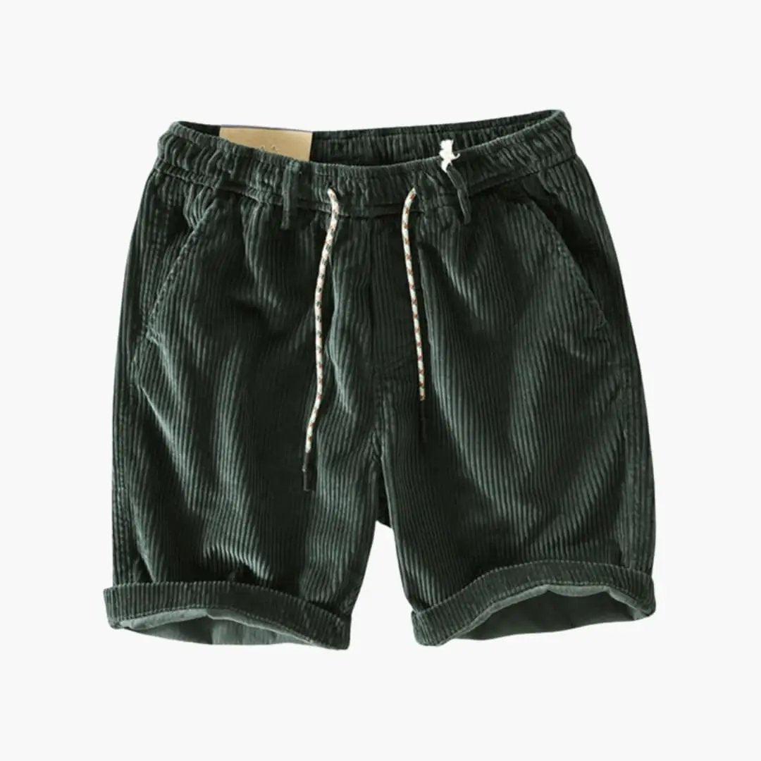 Men's corduroy shorts in dark green with elastic waistband and side pockets.