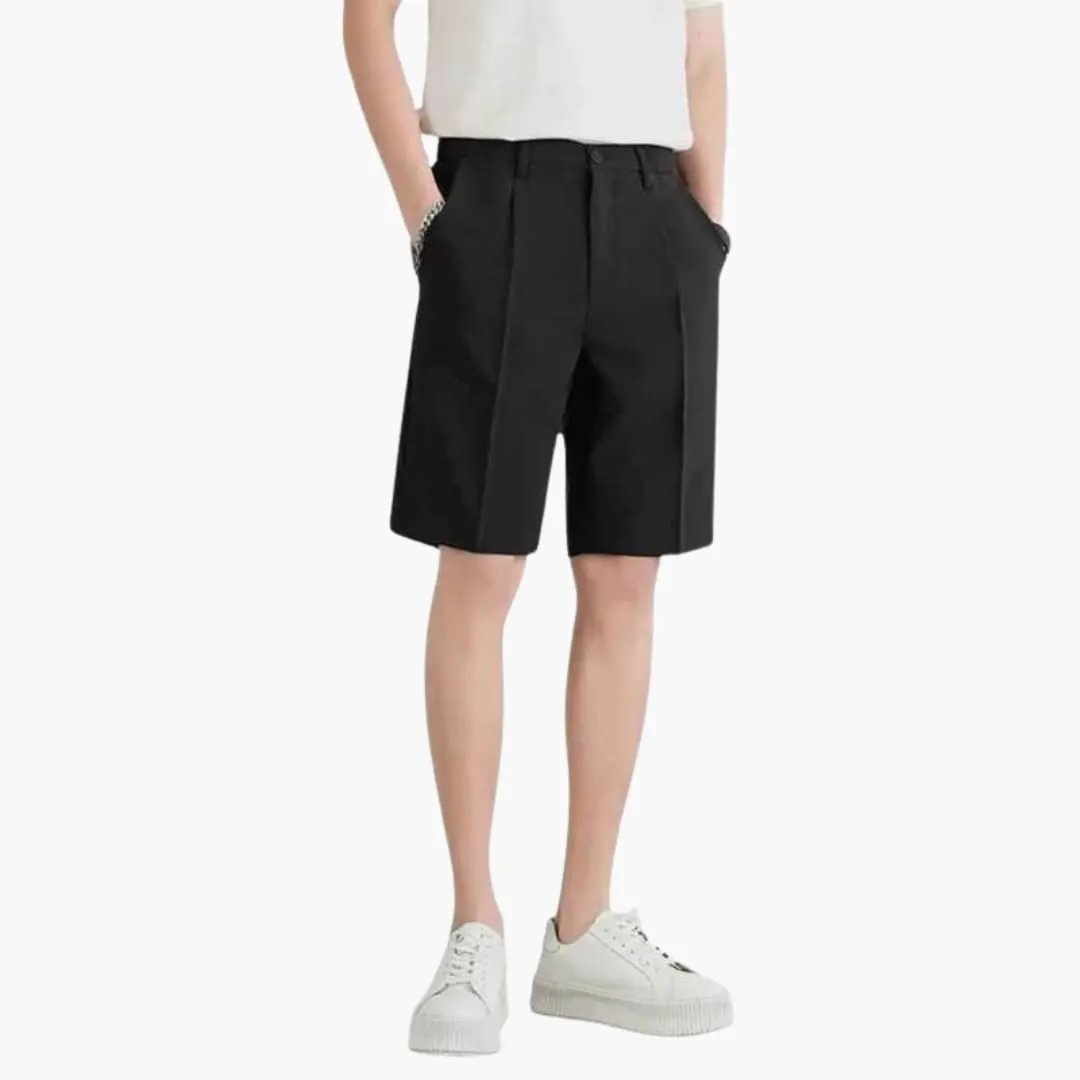 Men's Wilfred Smith pleated chino shorts with zipper and belt loops, knee-length, black, shown with white sneakers