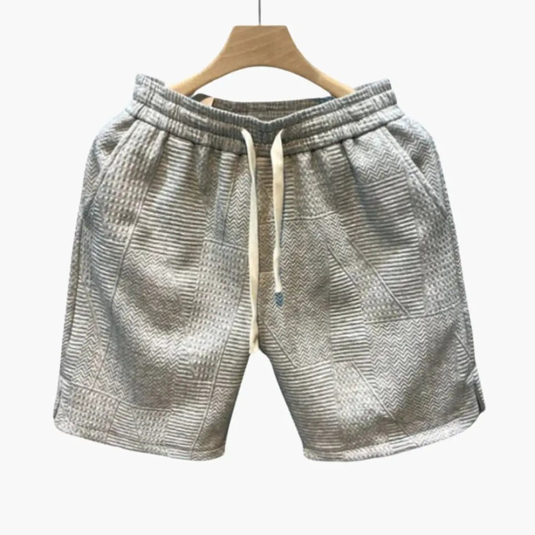 Men's jogger shorts with elastic waistband and drawstring in grey geometric patchwork print