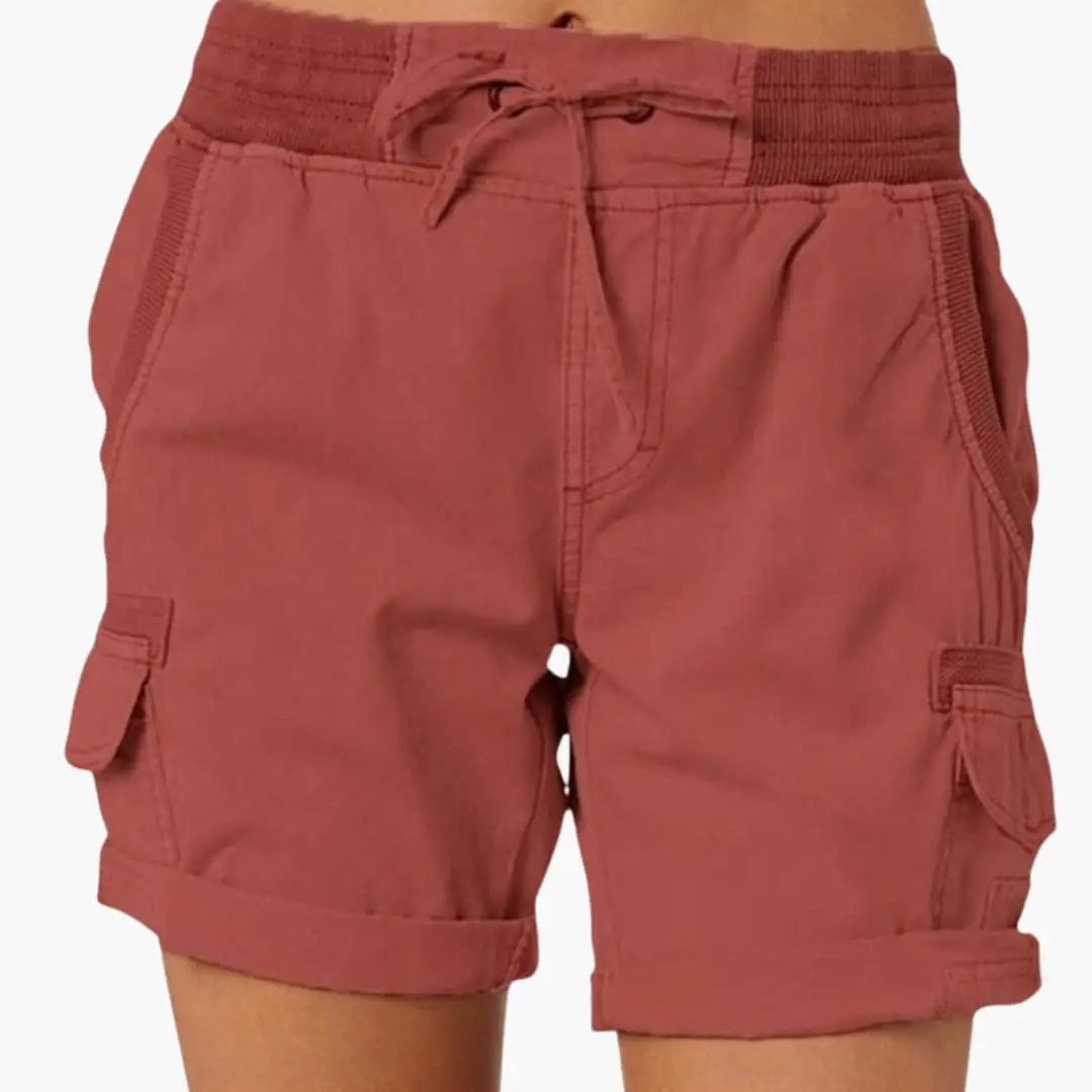 Women’s cargo shorts with drawstring waist in rust red, featuring front pockets and side cargo pockets