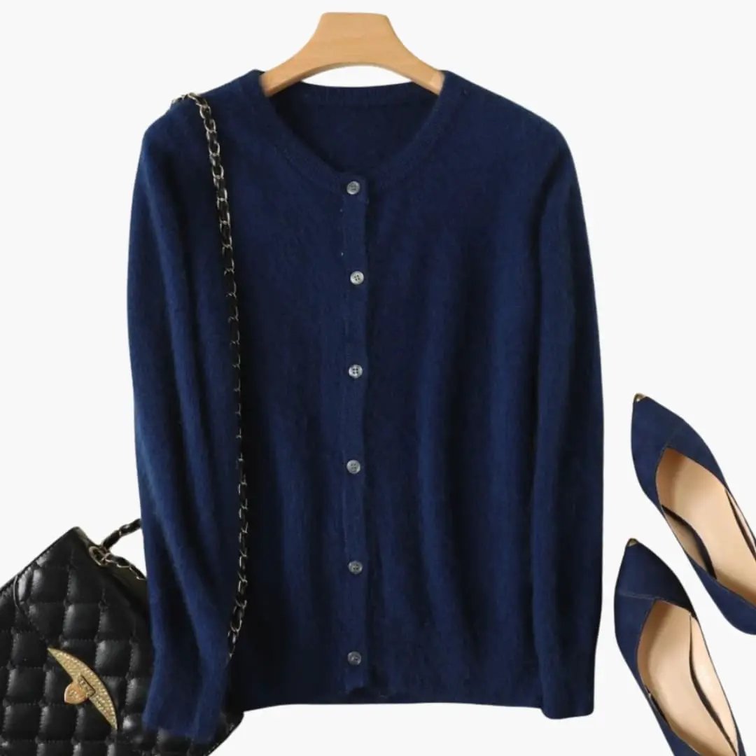Women’s Cardigan by Wilfred Smith, navy knit with button front and cuffs, shown with 2 blue heels and a black bag.