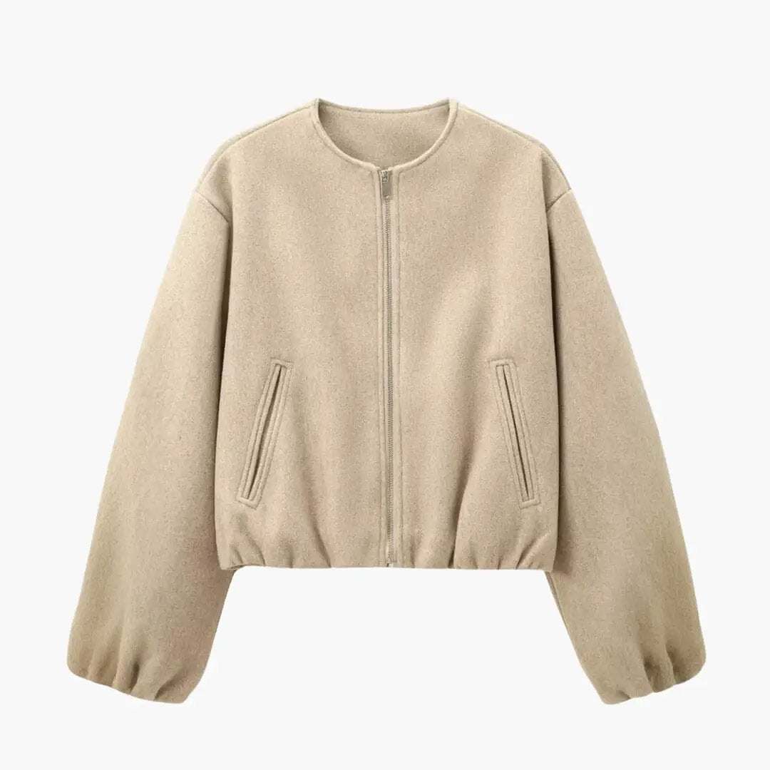 Women’s cropped bomber jacket in beige with front zipper closure and long puff sleeves.