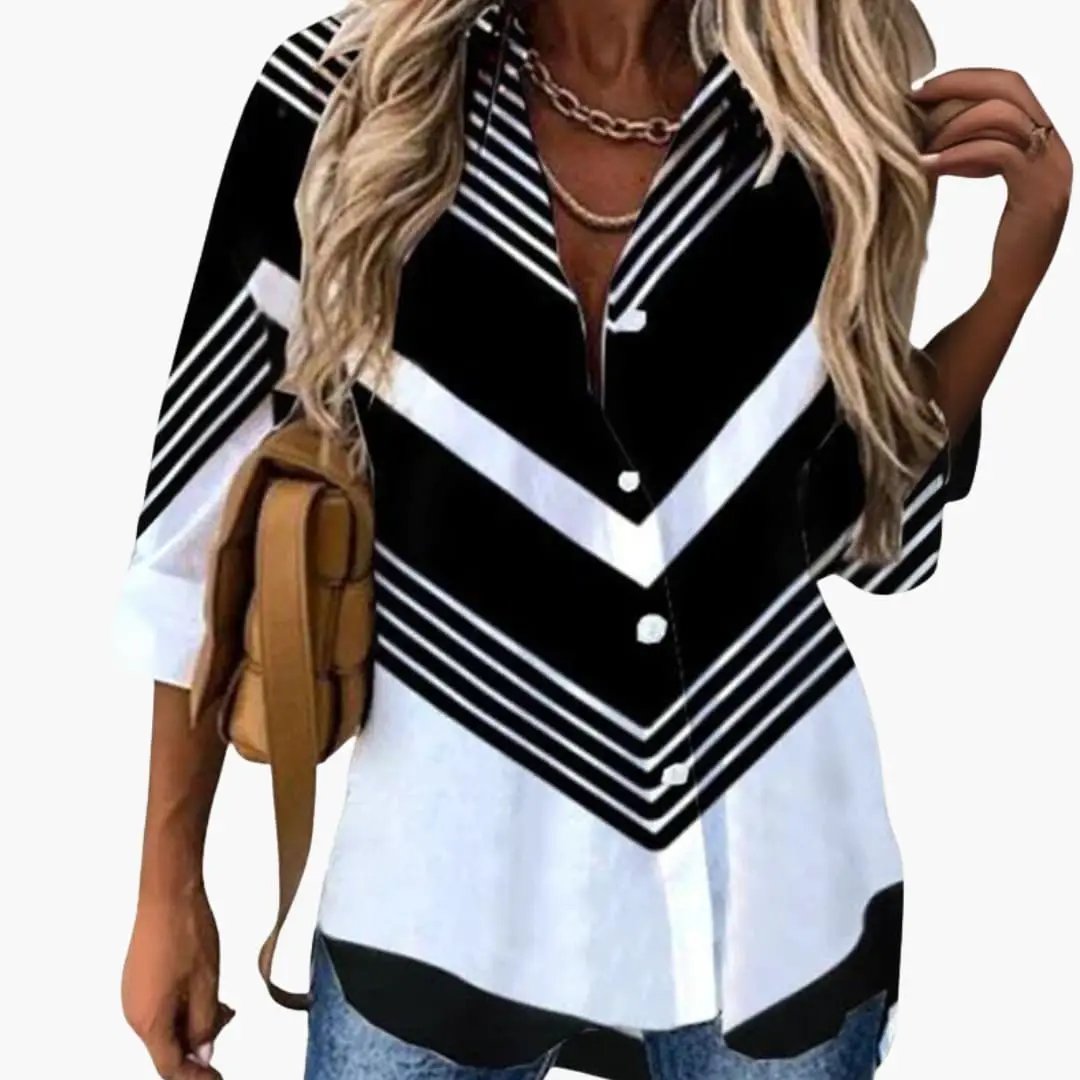 Women's blouse with black and white chevron print, long sleeves, paired with a tan crossbody bag