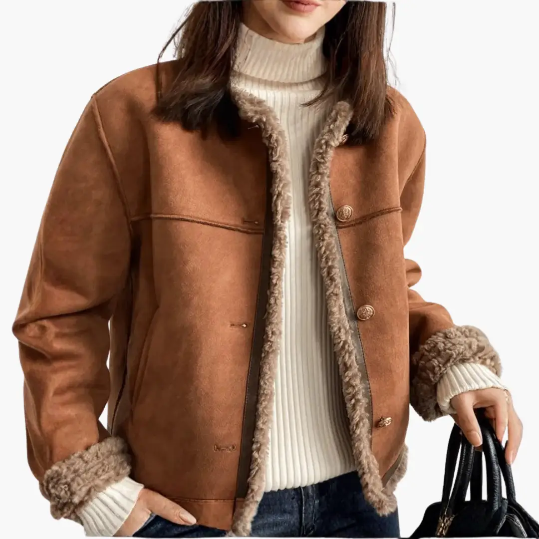 Women’s jacket with sherpa-style trim by Wilfred Smith; tan suede short coat with shearling trim.