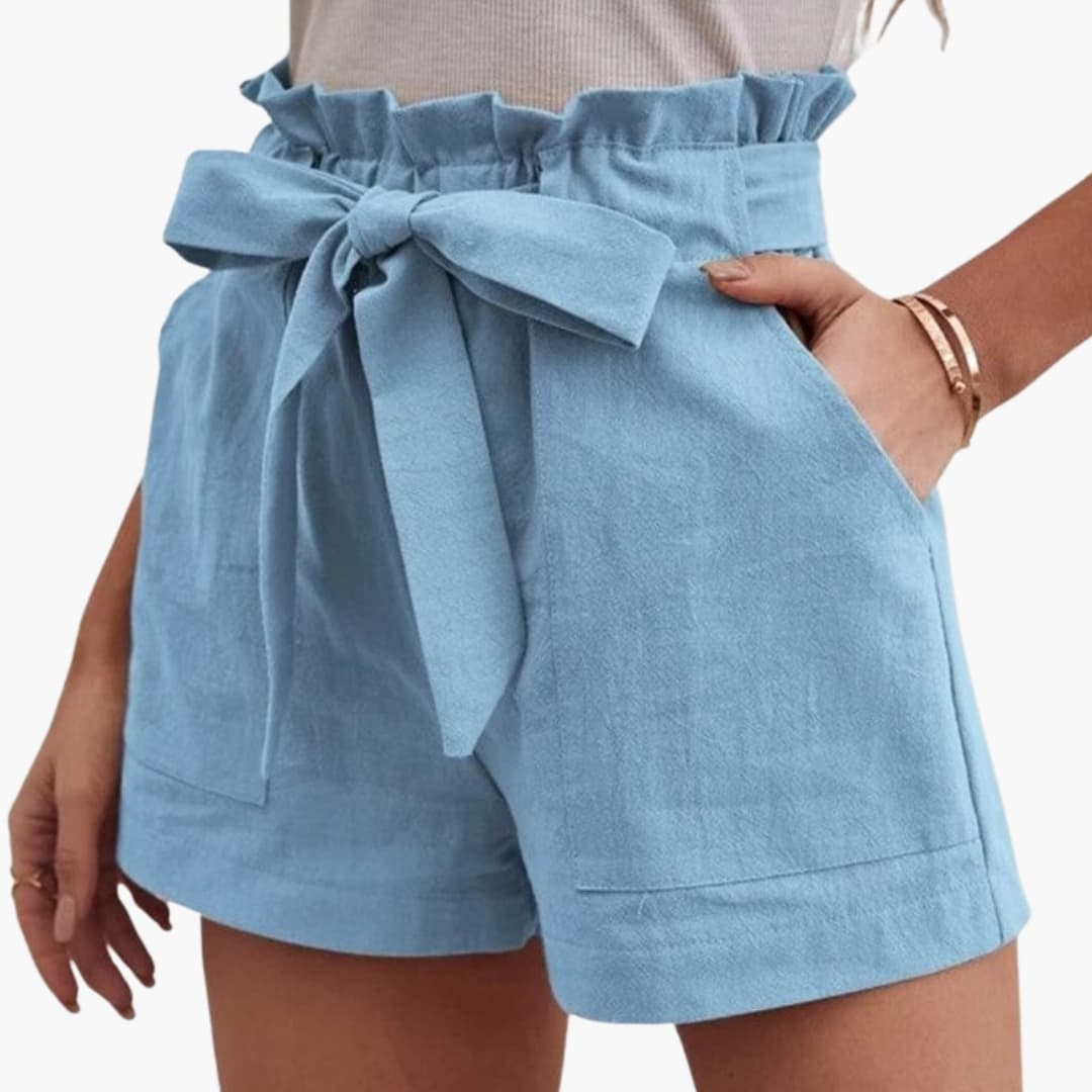 Women's linen shorts by Wilfred Smith with a tied belt and wide waistband in light blue with side pockets