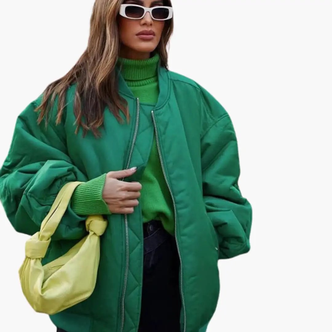 Women's oversized green bomber jacket with round neck, paired with a lime-yellow handbag