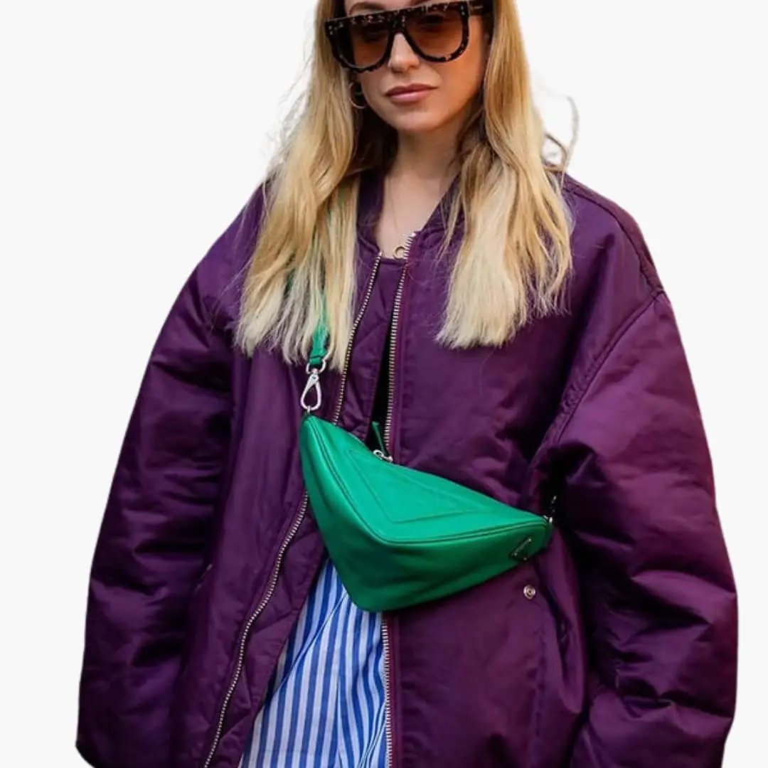 Women's oversized bomber jacket with round neck in purple, paired with a green waist bag