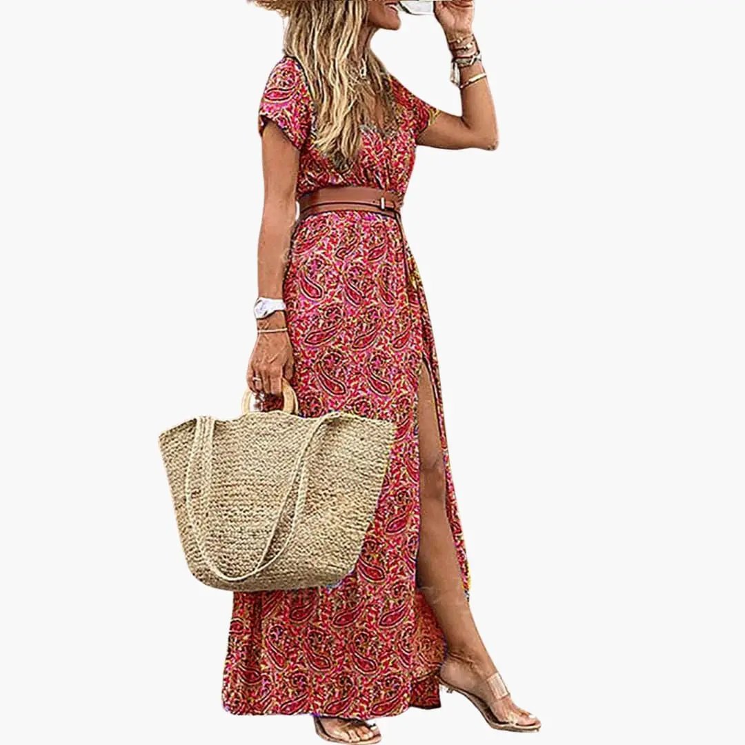 Women’s maxi dress with belt, short sleeves, gathered waist in red paisley print with side slit.
