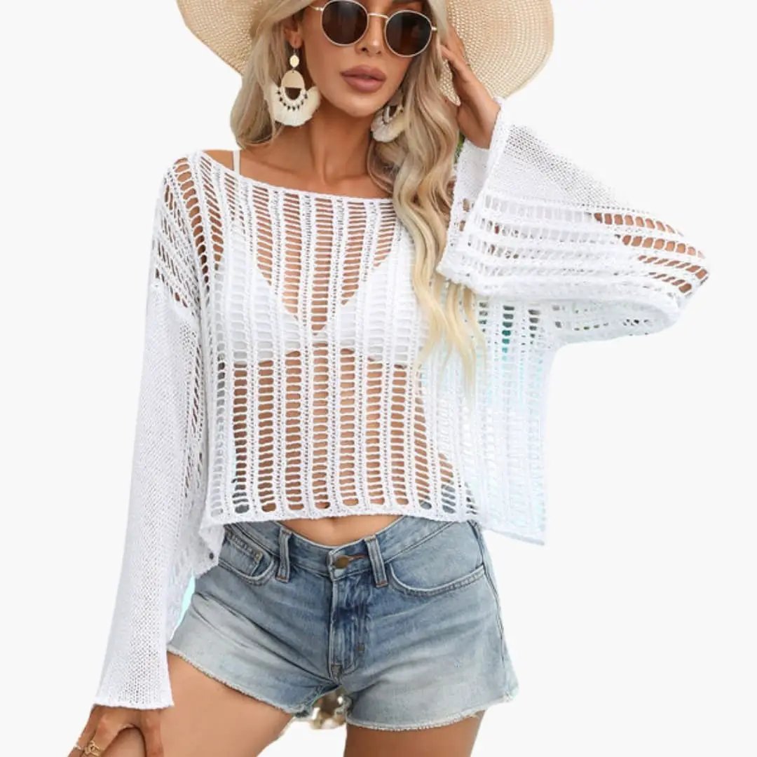 Women's white mesh top with round neck and long sleeves, cropped length paired with denim shorts.