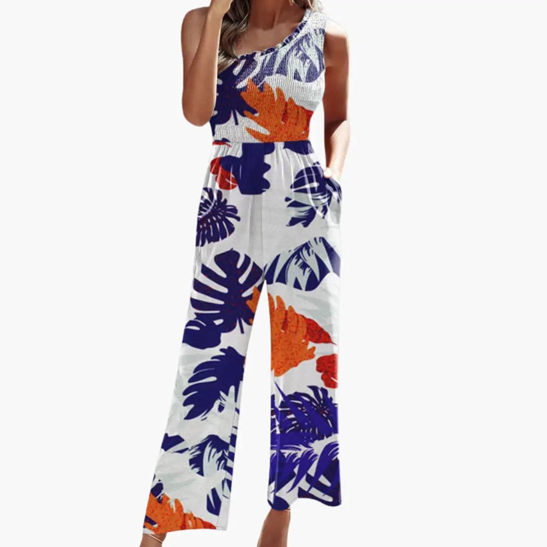 Women’s one-shoulder wide-leg jumpsuit by Wilfred Smith in tropical blue and orange leaf print with pockets.