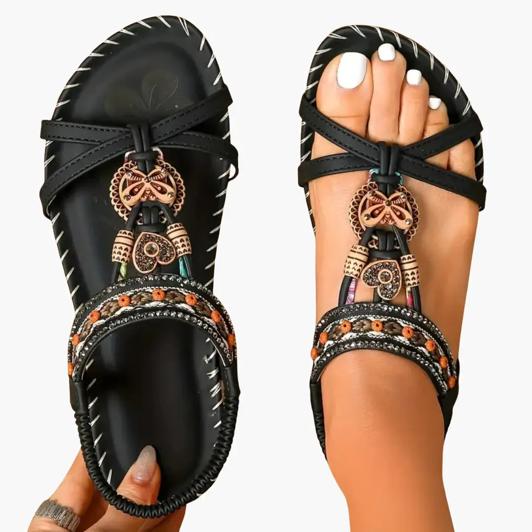 Pair of orthopedic sandals with supportive soles and flexible fit by Wilfred Smith, black sandals with orange beaded trim
