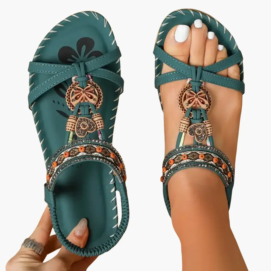 Pair of Wilfred Smith women's orthopedic sandals in teal with beaded straps and charms