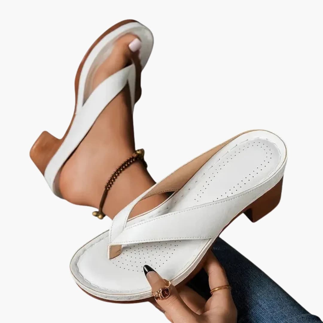 Pair of white women's orthopedic sandals with contoured footbed, cross-strap design and textured sole.