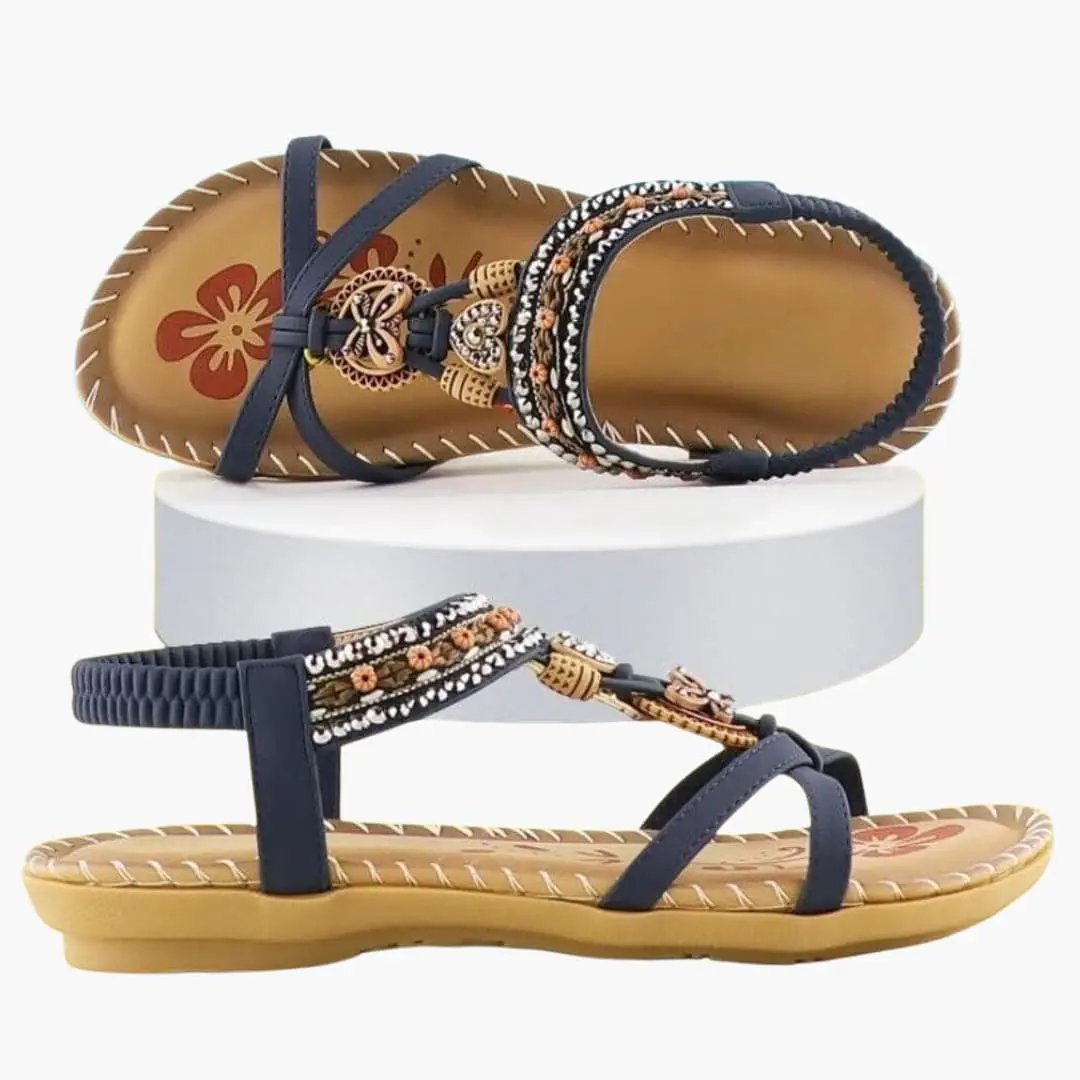 Pair of women's platform sandals with navy elastic straps, beaded embroidered accents, and cushioned tan soles