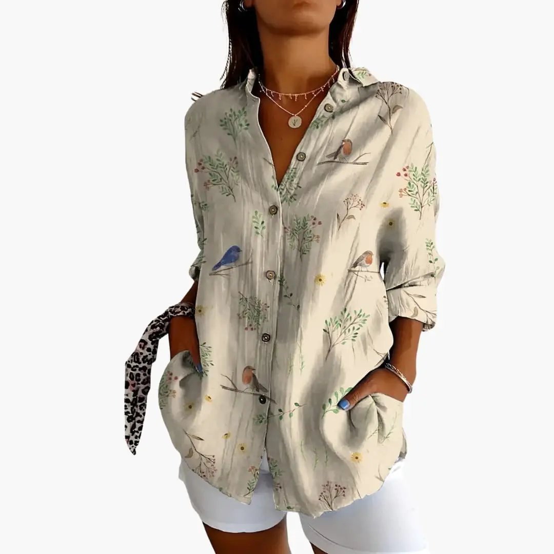 Women’s printed blouse, beige short-sleeve loose-fit top with birds and botanical print, lightweight fabric.