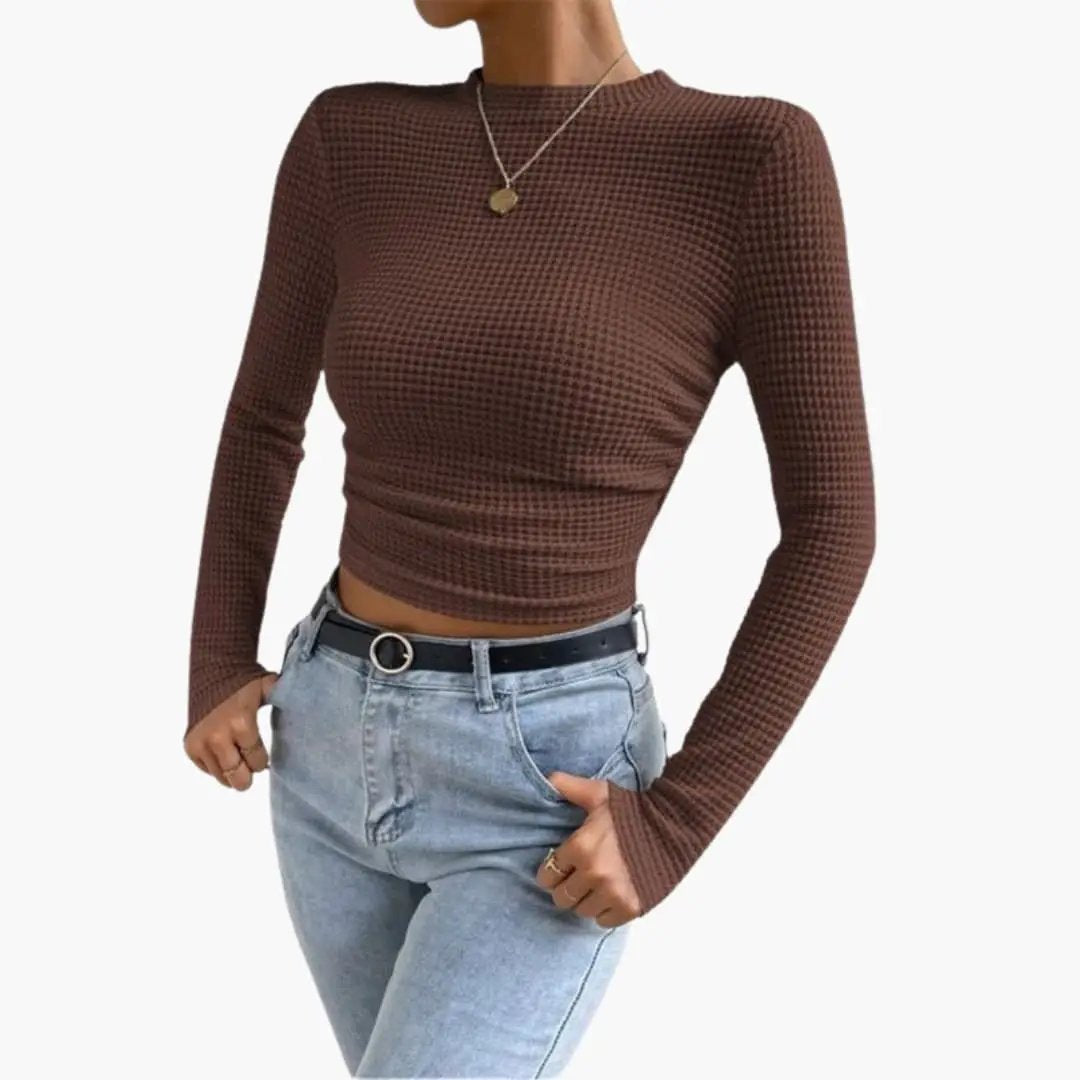 Women's brown ribbed long-sleeve crop top worn with light-wash jeans and a black belt