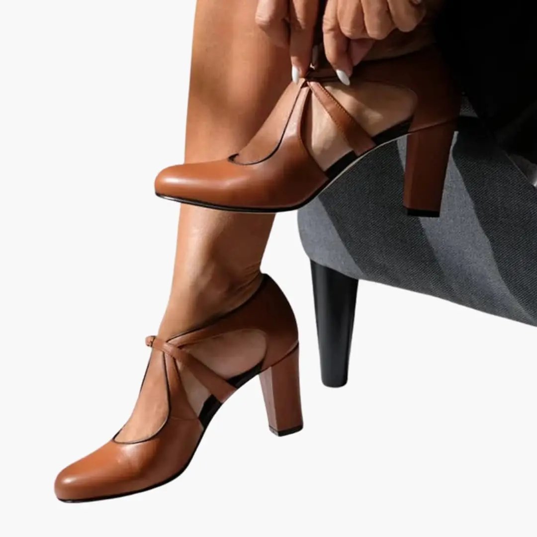 Women's tan leather sandals with cutout upper and ankle strap, block heel.