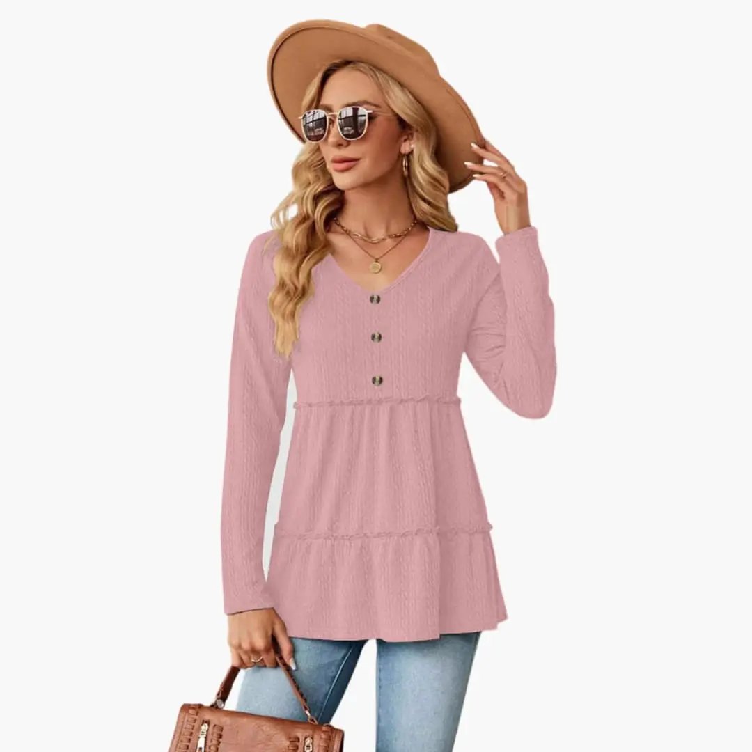Women's pink tunic top with V-neck, button accents, long sleeves and flowing hem.